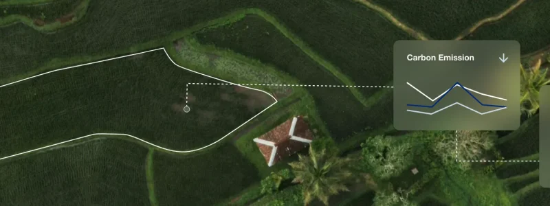 Aerial view of farmland with carbon emission and environmental alerts dashboards overlayed for monitoring.